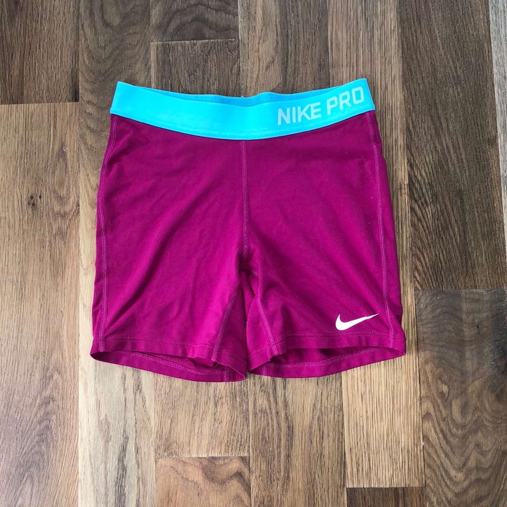 Hot pink and blue Nike Pros